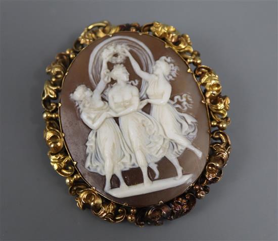 An Edwardian yellow metal mounted oval cameo pendant brooch, carved with the Three Graces, 54mm.